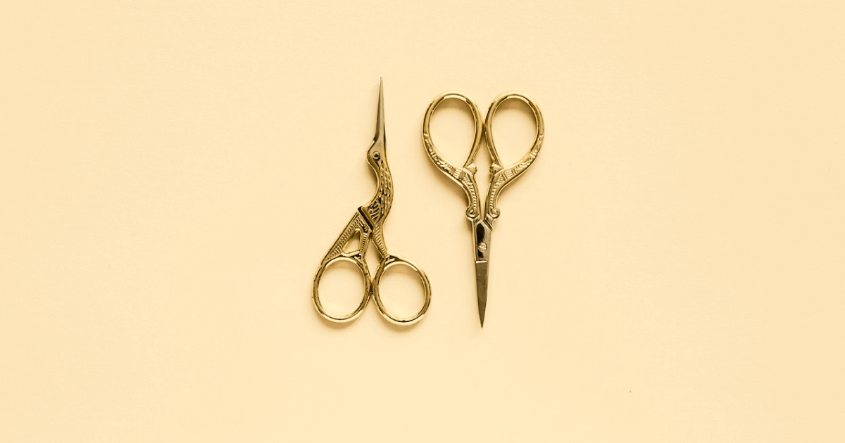 two golden scissors, they are both patterned